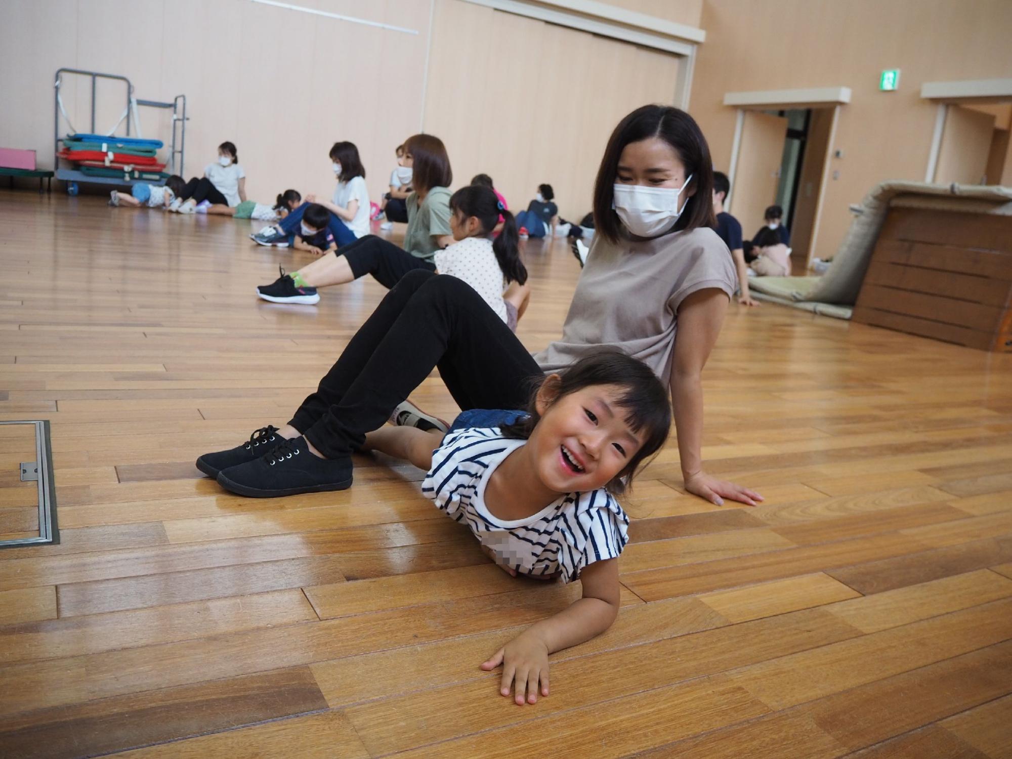 保護者の足のトンネルをくぐる子ども