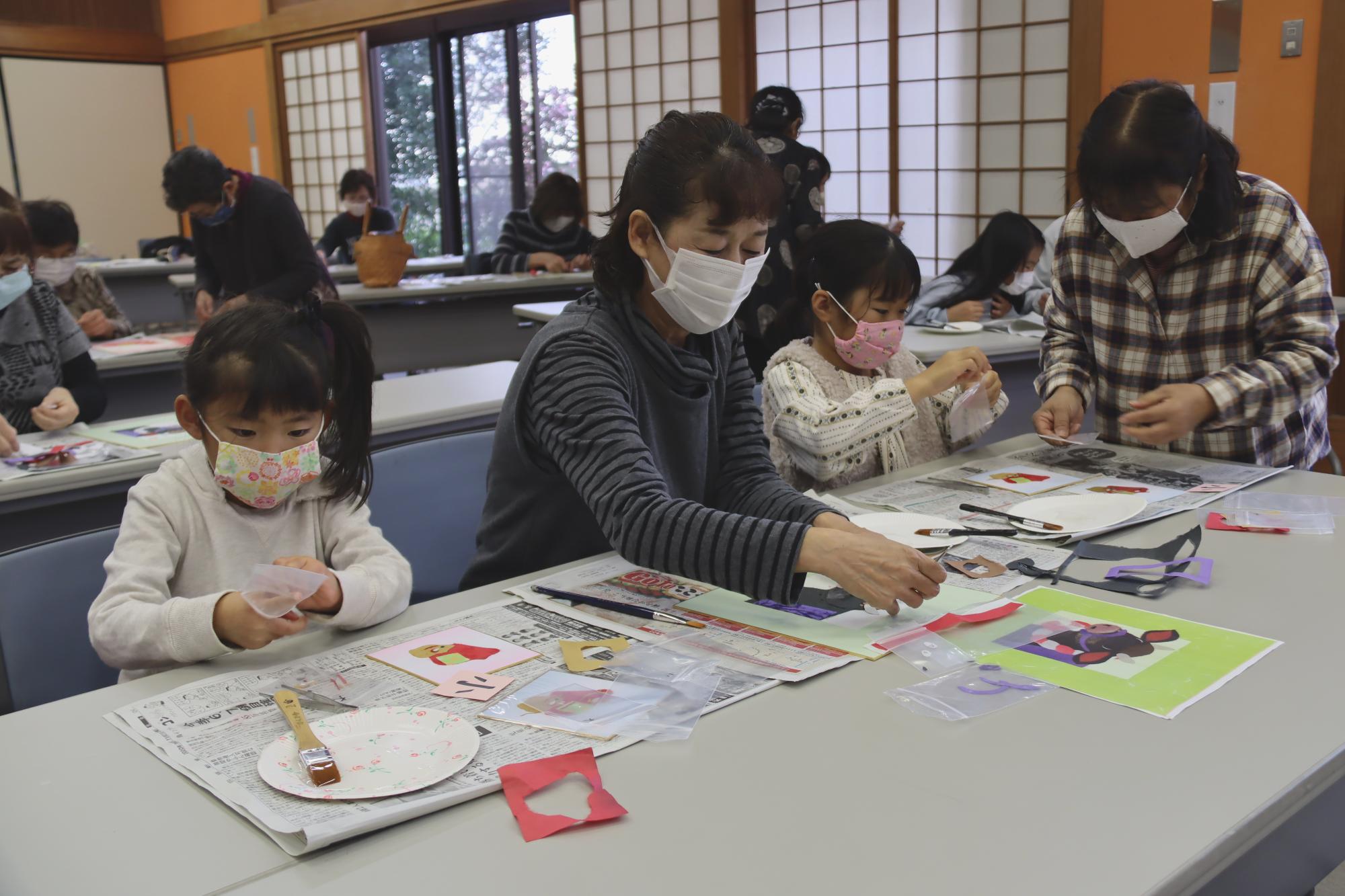 ちぎり絵で色紙をかざる参加者