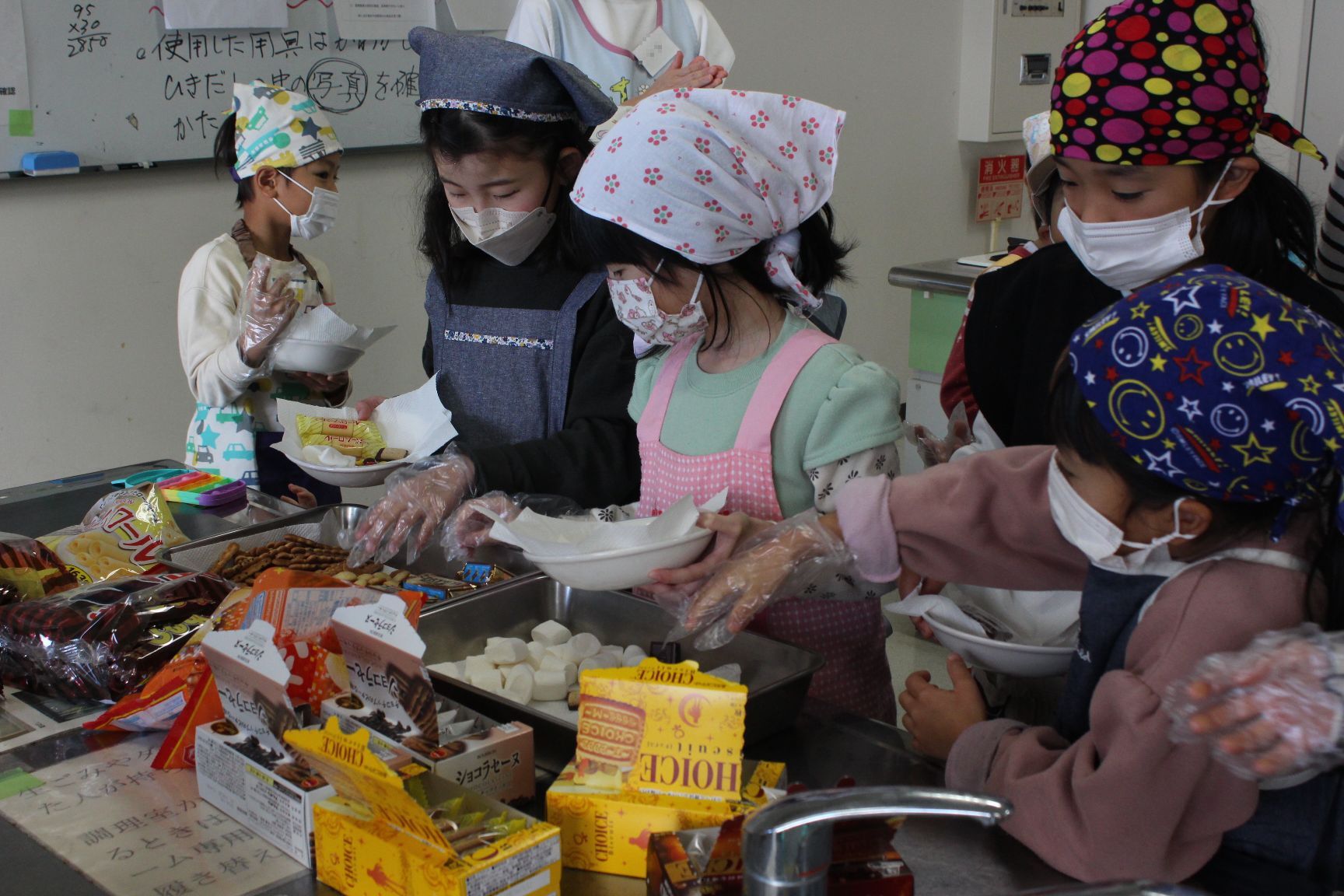 盛り付けるお菓子を選ぶ子どもたち