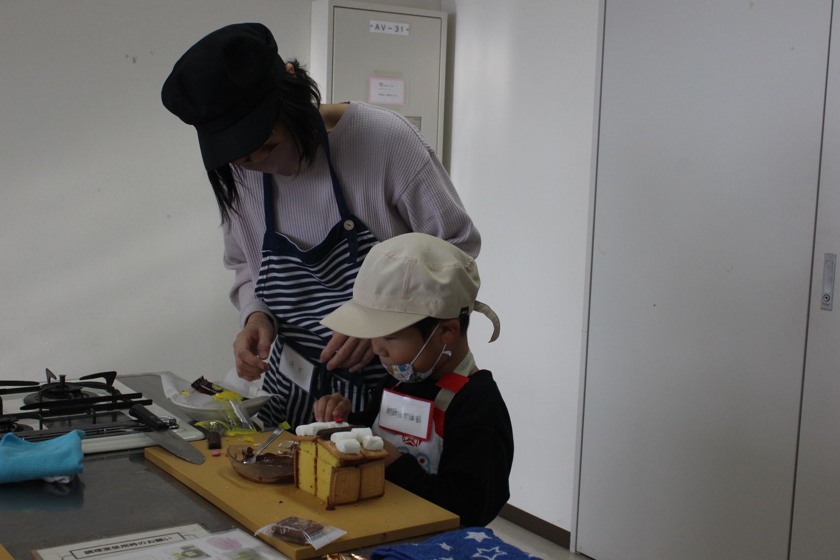 お菓子を飾り付けする親子