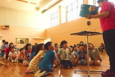 絵本の読み聞かせを興味深く真剣に聞いている子供たちの写真