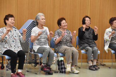 女性の参加者5名が椅子に座り足踏みをしている写真